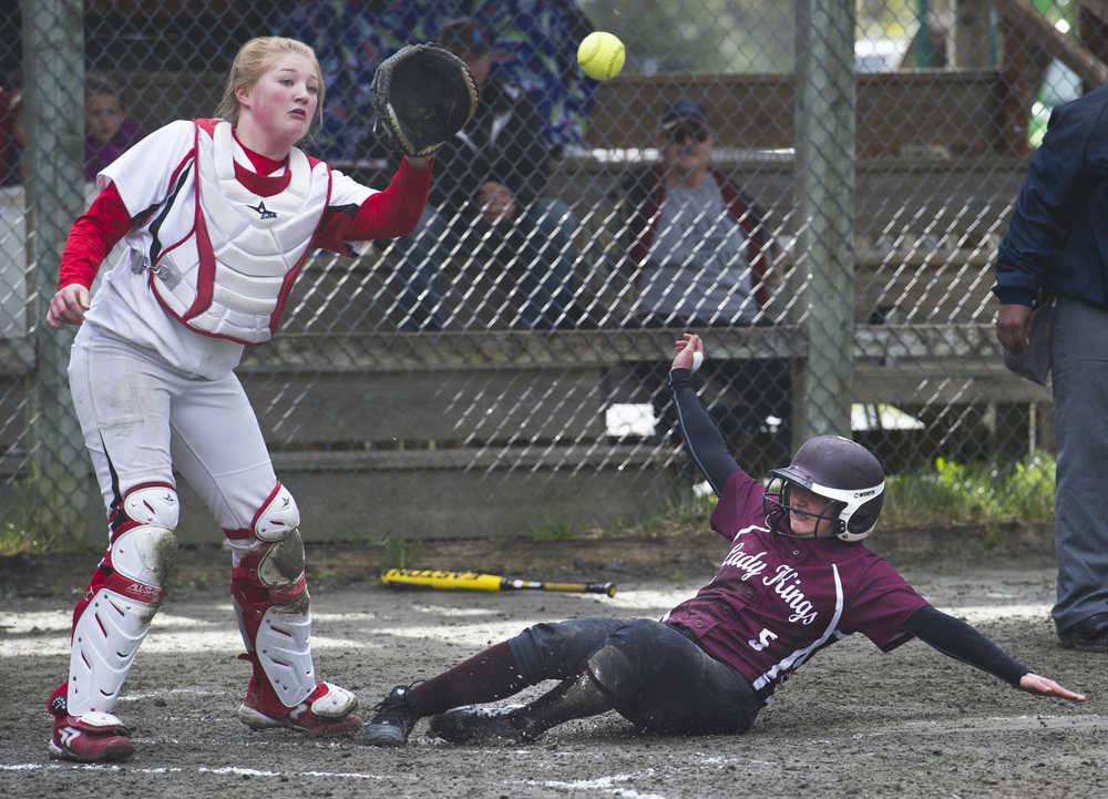 Ketchikan's J. Miller slides safely into home as Juneau-Douglas' Morgan Balovich waits for the throw during their game at Melvin Park on Friday.