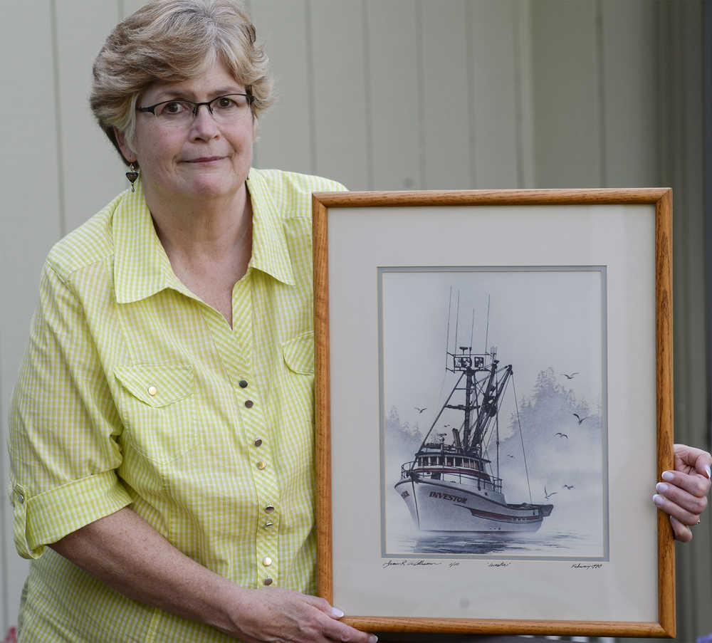 In this photo taken Wednesday, April 20, 2016, Laurie Hart poses with a painting of her brother Mark Coulthurst's fishing vessel the Investor  painted by local artist James Williamson, at her home in Blaine, Wash. home. Almost 34 years ago, Mark Coulthurst, 28, the Investor's skipper; his pregnant wife, Irene Coulthurst, also 28; their two children, Kimberly, 5, and John, 4; and Michael Stewart, 19, of Bellingham, a cousin of Mark Coulthurst, were killed aboard the Investor, a purse seiner found ablaze Sept. 7, 1982, near Craig, a fishing village in Southeast Alaska. (Philip A. Dwyer/The Bellingham Herald via AP) MANDATORY CREDIT