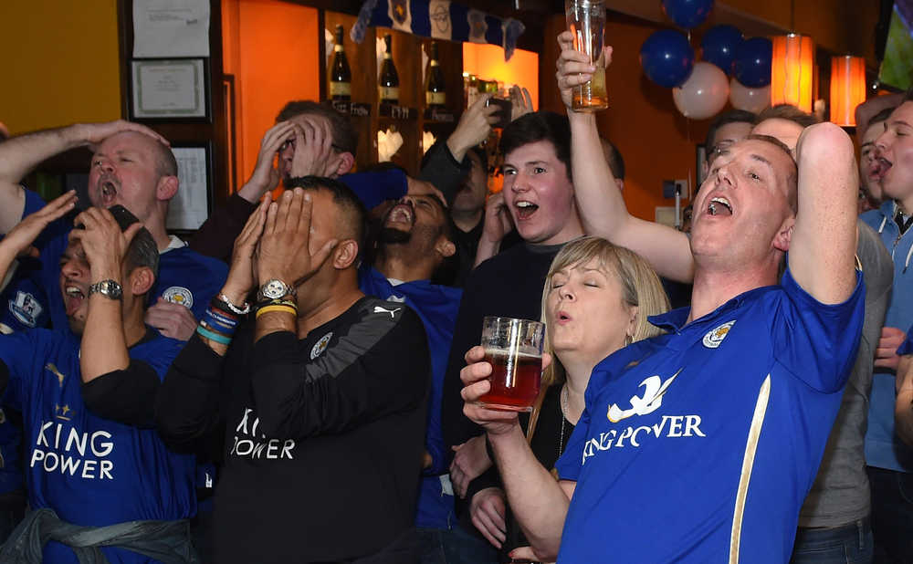 Leicester City fans react as they watch the Chelsea versus Tottenham Hotspur English Premier League soccer match at the Local Hero public house in Leicester, central England, Monday May 2, 2016. (Joe Giddens/PA via AP) UNITED KINGDOM OUT  NO SALES NO ARCHIVE