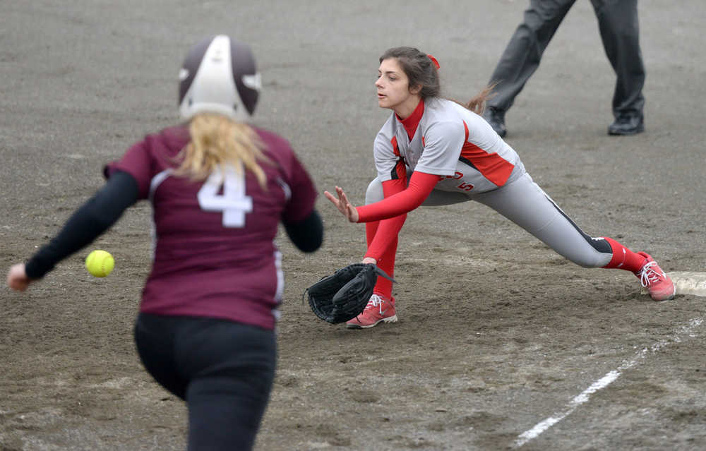 Juneau-Douglas first baseman Leah Spargo (5) stretches to make an out Thursday during the Crimson Bears' 7-0 win against Ketchikan High School at Norman Walker Field in Ketchikan.