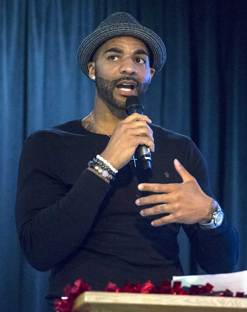 NBA player and former Juneau-Douglas High School star Carlos Boozer makes a surprise visit during the JDHS Basketball Awards Banquet at Elizabeth Peratrovich Hall Tuesday evening. Boozer came to help celebrate the team's first state championship since he helped JDHS win one 18 years ago.