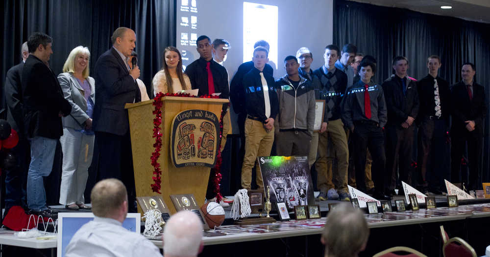 Gov. Bill Walker and members of the Juneau legislative delegation, Sen. Dennis Egan, Rep. Sam Kito III and Rep. Cathy Muñoz, congratulate the Juneau-Douglas High School boys basketball team for winning the state championship during an award banquet at the Elizabeth Peratrovich Hall Tuesday evening.