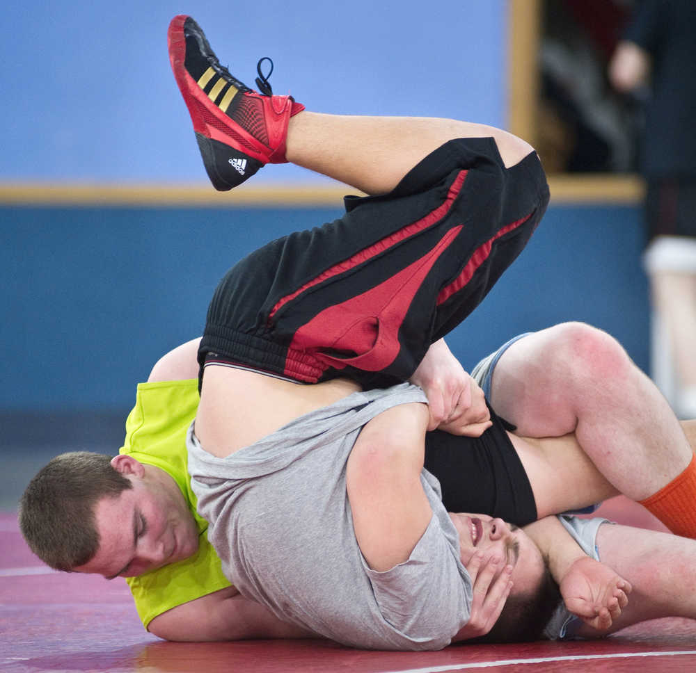 J.D. Hudson, left, wrestles with teammate Taylor Sutak during the Juneau-Douglas High School wrestling practice at the Marie Drake gymnasium.