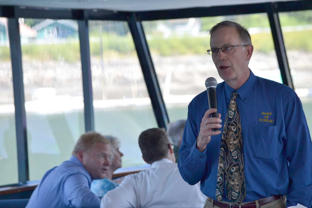 Juneau Port Director Carl Uchytil speaks to the Juneau Chamber of Commerce's weekly luncheon crowd on an Allen Marine tour boat. Uchytil led Thursday's harbor tour along with City Manager Rorie Watt.