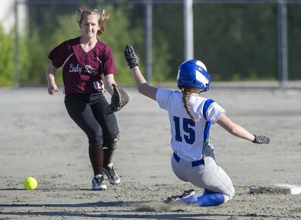 Thunder Mountain's Haleigh Dicarlo slides safely into second base as Ketchikan's Kayla Schaffer watches an errant throw go by at Dimond Park on Friday.