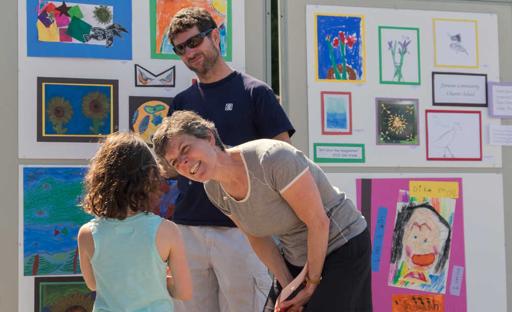 Juneau schools arts specialist Nancy Lehnhart, 51, talks with Delphine Hochstoeger, 6, about art as her father Peter looks on at the 14th annual UAS Community Day on Saturday.