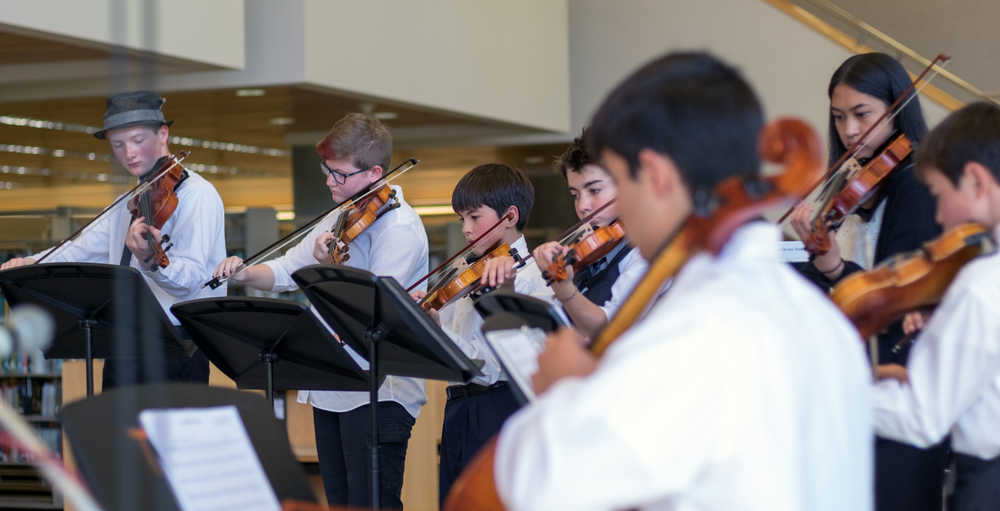 Little Dipper String Ensemble performs in the library of the campus at the 14th annual UAS Community Day on Saturday.