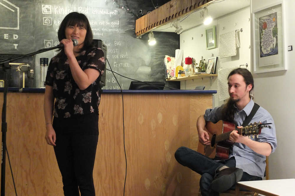 Christy NaMee Eriksen, owner of Kindred post, performs one of her poems as Guy Unzicker accompanies her at a Tiny Post Office concert in September 2015. Eriksen this year received a Rasmuson Individual Artist Award. She'll use that award to create videos of her performing new and revised poems. Photo by Mary Catharine Martin.