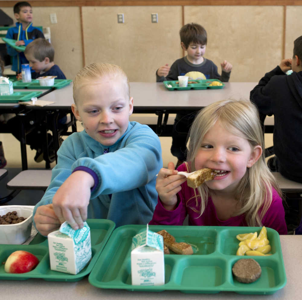 First-graders Sammie Jo Quintal, left, and Bailey Deems eat breakfest before school starts at Glacier Valley Elementary on Wednesday. The Juneau Community Foundation and United Way of Southeast Alaska donated $18,104 to help the Juneau School District offer free breakfast for all students next year at most elementary schools and grab and go foods where a breakfast cannot be offered.