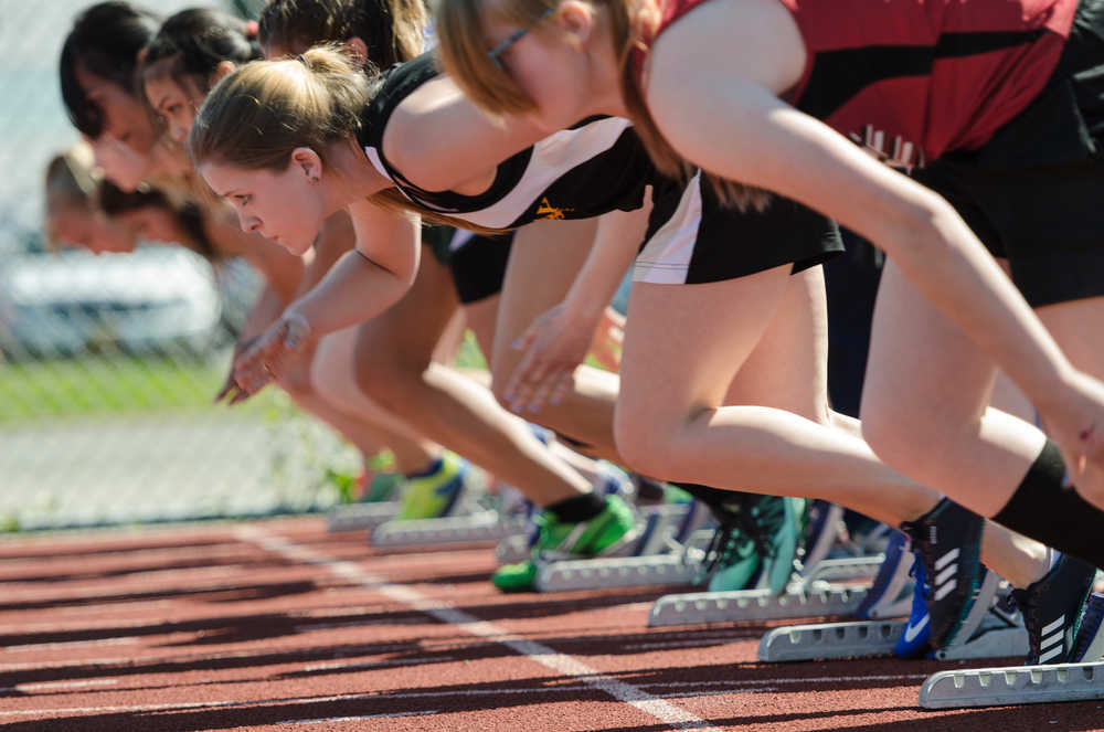 Runners take off from their starts during their 100 meter event Saturday morning at Thunder Mountain Field.