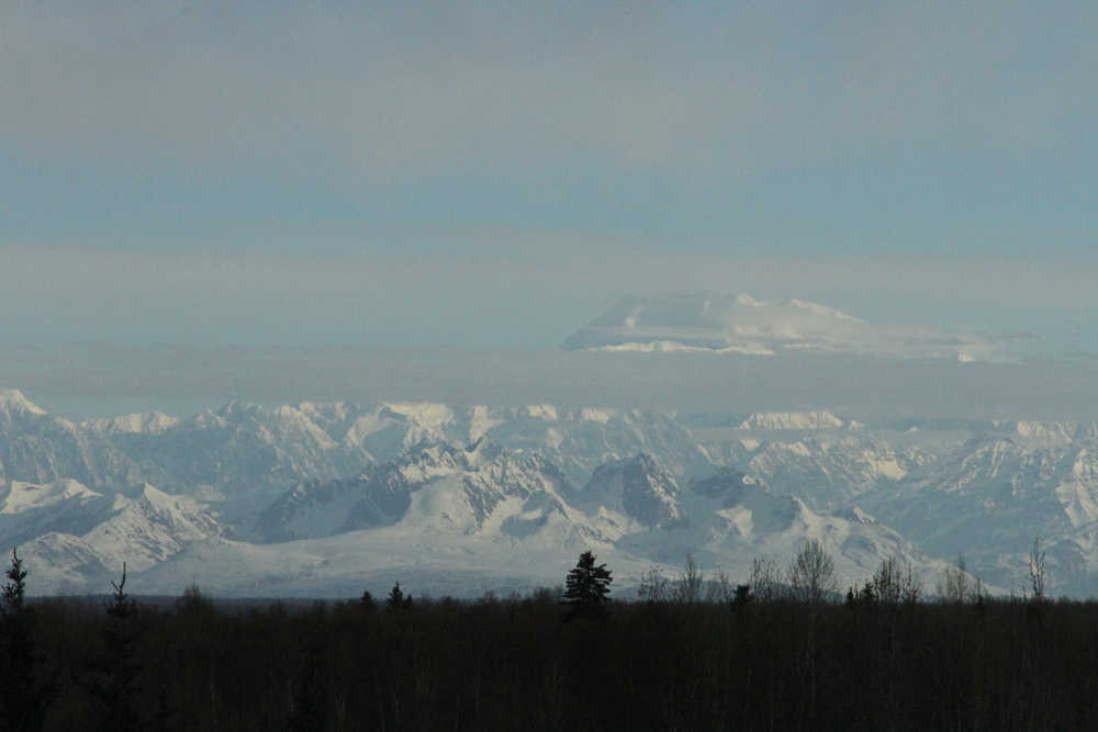 This photo taken Sunday, April 24, 2016, in Talkeetna, Alaska, shows Denali partially obscured by clouds. The U.S. Army helped the National Park Service by using Chinook helicopters to fly food and materials to set up base camps at the 7,200-foot and 14,000-foot level to assist climbers on North America's tallest mountain. (AP Photo/Mark Thiessen)