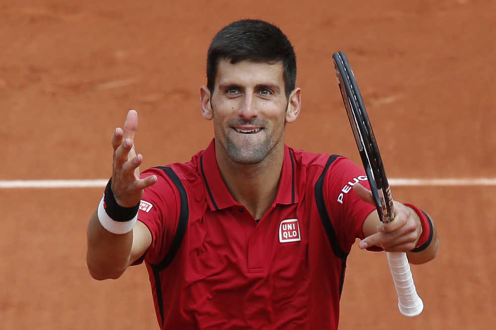 Serbia's Novak Djokovic acknowledges the cheering crowd after winning his first round match of the French Open tennis tournament against Yen-Hsun Lu of Taiwan at the Roland Garros stadium in Paris, France, Tuesday, May 24, 2016. (AP Photo/Michel Euler)