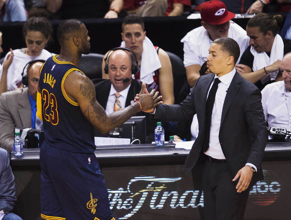 Cleveland Cavaliers forward LeBron James (23) clasps hands with coach Tyronn Lue during the second half of Game 6 of the Eastern Conference finals against the Toronto Raptors on Friday. The Cavaliers won 113-87 and advanced to the NBA Finals.