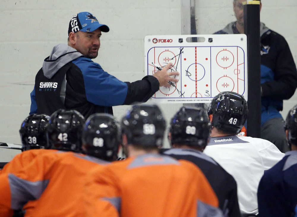 San Jose Sharks head coach Peter DeBoer, top, talks to his team during an NHL hockey practice Friday in San Jose, California. San Jose will play Pittsburgh in the Stanley Cup Final.