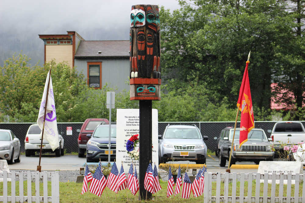 Twelve flags surround the Southeast Alaska Native Veterans Memorial Park totem pole in honor of the 12 Southeast Alaskan servicemen who lost their lives serving their nation. The flags were placed by Alaska Native veterans during Monday's Memorial Day service.