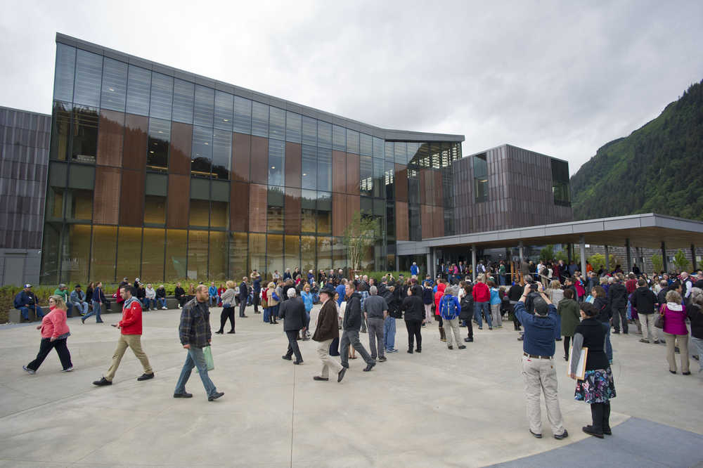 Juneau residents and visitors gather in front of the Andrew P. Kashevaroff State Library, Archives and Museum for the grand opening on Monday.