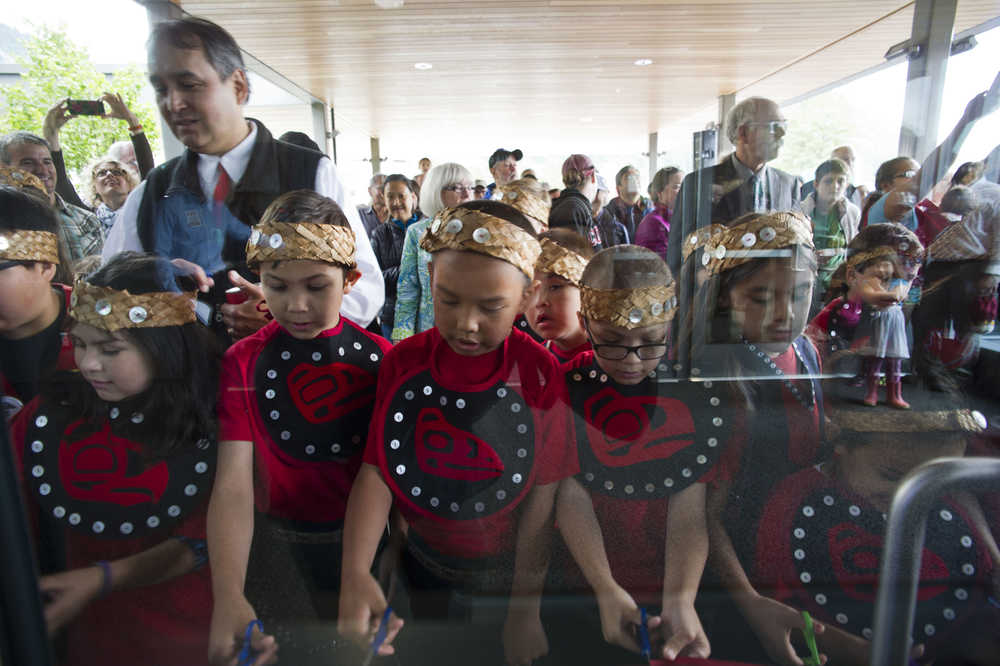 Students from Harborview Elementary School's Tlingit Culture Language and Literacy program cut the ribbon during the grand opening of the Andrew P. Kashevaroff State Library, Archives and Museum on Monday.