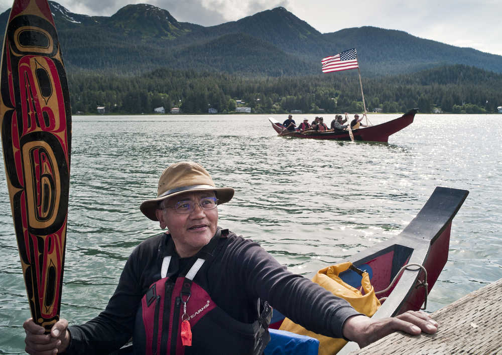 Wayne Price of Haines reaches for the dock at the Wayside Park on Channel Drive as he skippers one of two canoes arriving from Hoonah Tuesday for Celebration 2016. The canoes will take part in a Coming Ashore Ceremony sponsored by the One Peoples Canoe Society at Sandy Beach on Wednesday from 11 a.m. to 1 p.m. A dozen canoes, each carrying 10 people, will be arriving from Kake, Ketchikan, Sitka, Angoon, Hoonah and Yakutat.