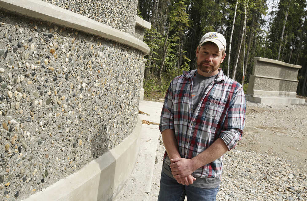 In this June 2 photo, Ron Rady poses next to the concrete walls his company installed at the Sgt. Scott Johnson and Trooper Gabe Rich Memorial Park in North Pole. Rady never thought he would be in a position to make this kind of contribution to his community. He arrived in Alaska in 2000 after deciding to get out of the Arizona heat.