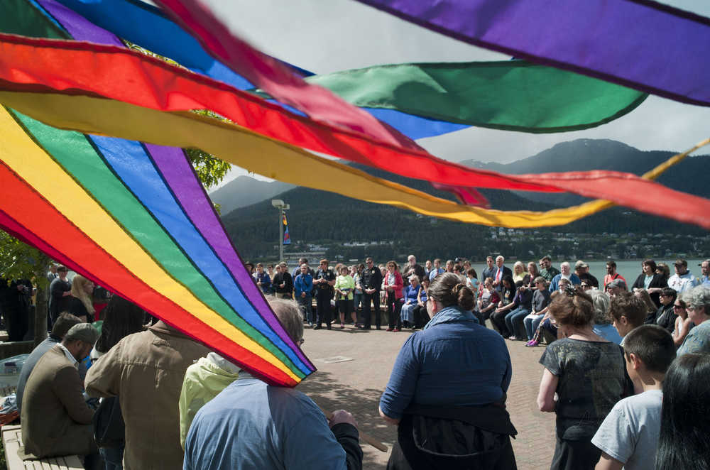 Juneau residents attend a noon vigil Monday at Marine Park for the victims of the Orlando shootings over the weekend.