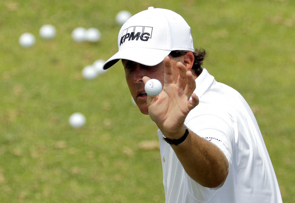 Phil Mickelson catches a ball from his caddie on the driving range before a practice round for the U.S. Open golf championship at Oakmont Country Club on Wednesday, June 15, 2016, in Oakmont, Pa. (AP Photo/Charlie Riedel)