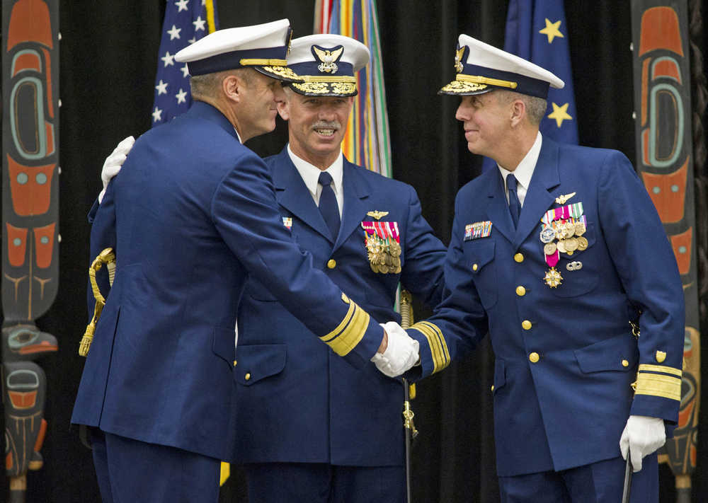 Rear Admiral Michael McAllister, left, takes over as Commander of the U.S. Coast Guard 17th District from Rear Admiral Daniel Abel, right, during a Change of Command ceremony at Elizabeth Peratrovich Hall on Wednesday. The ceremony was overseen by Vice Admiral Charles Ray, Commander of the Pacific Area and Defense Force West, center.
