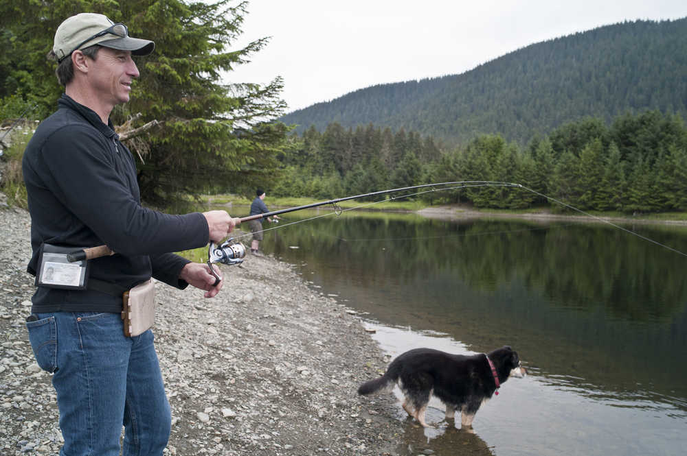 Paul Turnisky, owner of Chum Fun, fishes king salmon with his client, Skylar Joly, at Fish Creek Pond on Friday.