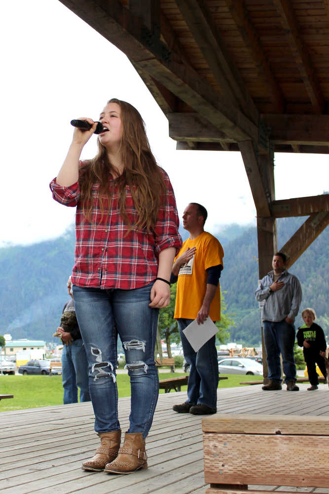 Elizabeth Bryson sings the national anthem Saturday, kicking off the first day of the 26th annual Gold Rush Days at Savikko Park where Southeast Alaska's mining and logging industries are celebrated with competitions, family activities and food.