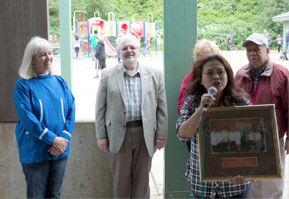Filipino Community President Josielind Ferrer, right, accepts a picture and frame from Rep. Cathy Muñoz, R-Juneau, left, during the Filipino Community Picnic on Saturday at Sandy Beach. Joining them were Rep. Bob Herron, D-Bethel, his wife Margaret, and Rafael Castanos, far right. The picture presented was of Alaska's first official trade mission to the Philippines in 2012 in which Muñoz and the Herrons took part. Following that trip Juneau established a sister city relationship in 2014 with Kalibo in the Philippine province of Aklan.