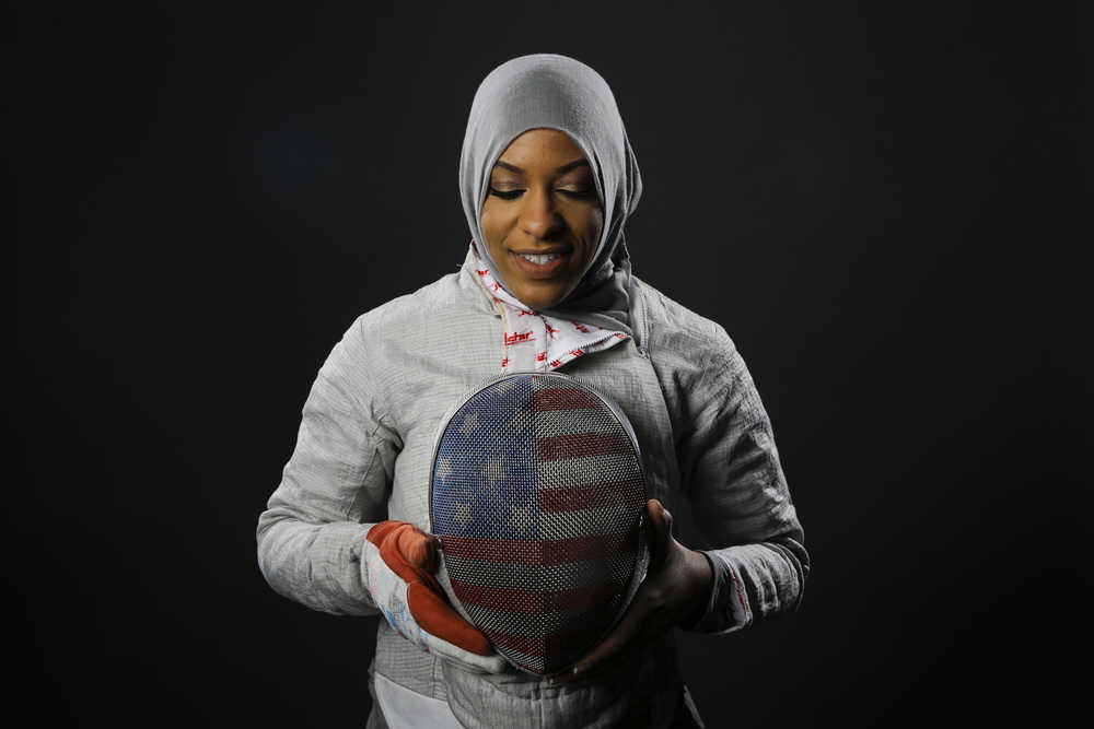 In this March 8 photo, Fencer Ibtihaj Muhammad poses for photos at the 2016 Olympic Team USA media summit in Beverly Hills, California. Muhammad will make history at the Rio Games by becoming the first American athlete to wear a hijab - a Muslim head scarf - while competing in the Olympics.