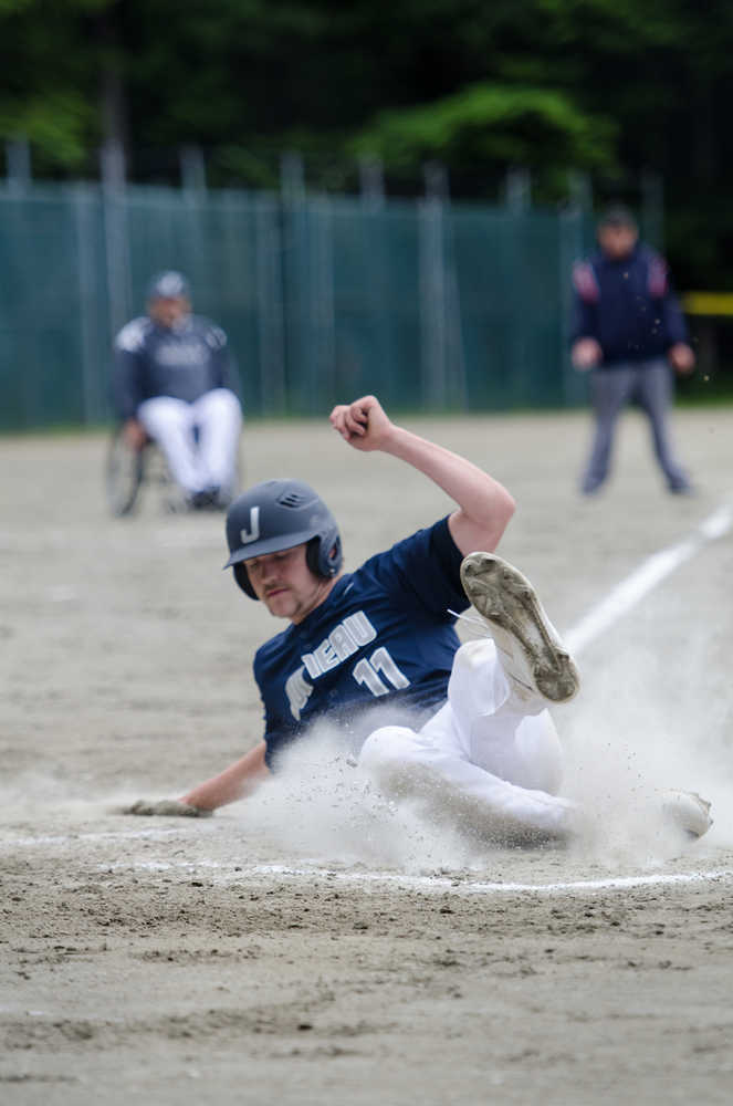 Juneau Post 25's Kasy Watts steals and slides to home base during their game against Chugiak Saturday afternoon at Adair-Kennedy Memorial Park.