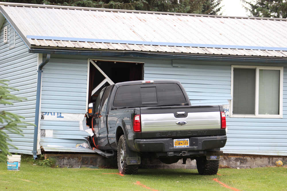 A Super Duty Ford truck is parked inside homeowner Scott Philip's bedroom Saturday morning in the 3700 block of Julep Street in the Mendenhall Valley. Philip and his son, William Philip, were the only ones home during the incident and neither of them suffered injuries. The driver's condition remains unknown.