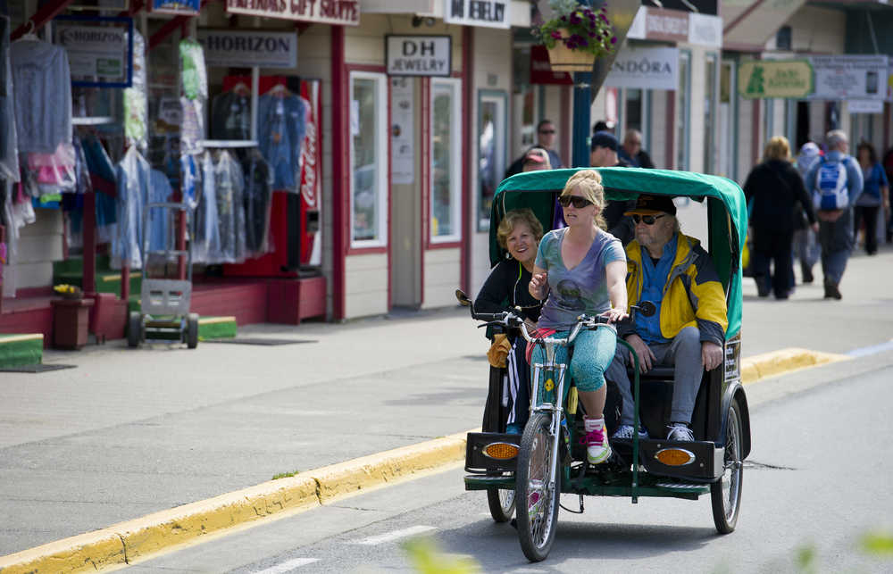 Melissa DeCook of Alaska Pedicab gives a couple a tour on South Franklin Street in early June.