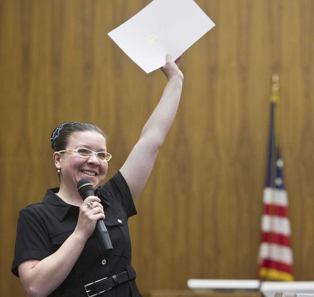 Olga Simpson of Belarus celebrates receiving her certificate during a U.S. Naturalization Ceremony at the Robert Boochever U.S. Courthouse in the Federal Building on Friday. Forty-one people from 10 countries became U.S. citizens.