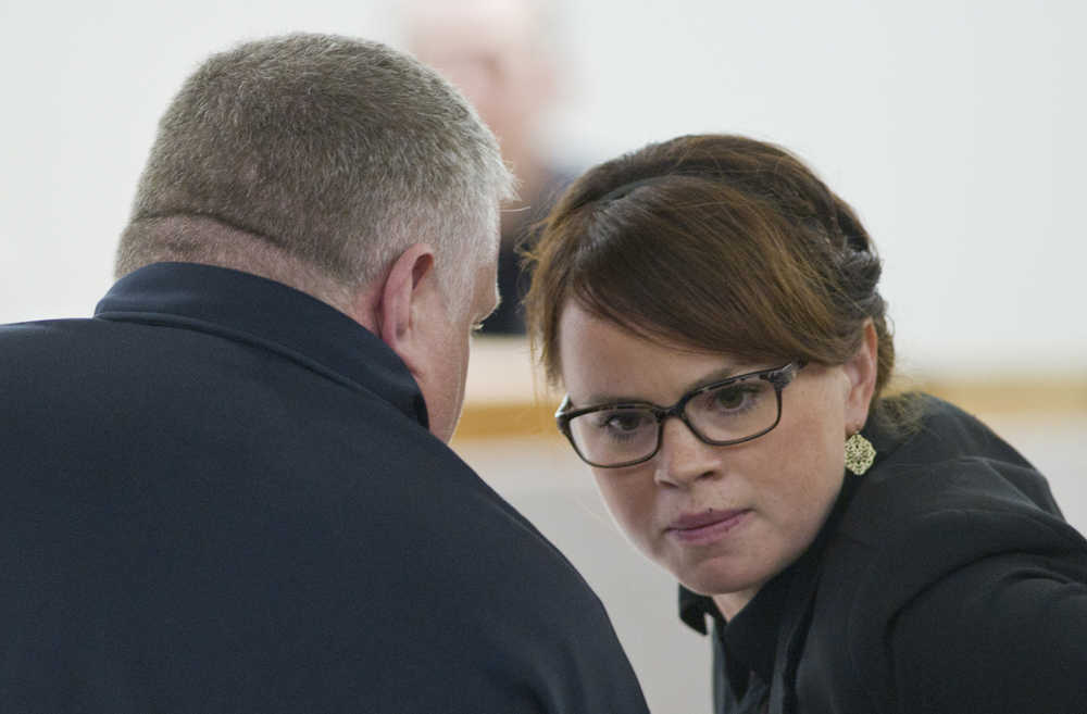Assistant District Attorney Angie Kemp speaks to Juneau Police Department Officer Jason Van Sickle during the trial of Leron Carlton Graham in Juneau Superior Court on Wednesday. Graham is representing himself on 14 counts of allegedly assaulting a woman and stealing a car in the Lemon Creek area in March.