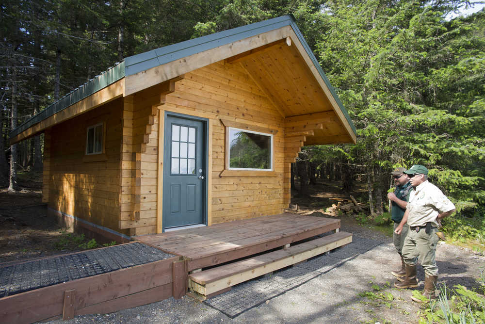 Kevin Murphy, right, chief ranger for the southeast area of Alaska State Parks, and Doug Drexel, southeast maintenance chief, view the new Salamander Cabin on Shelter Island on Thursday.