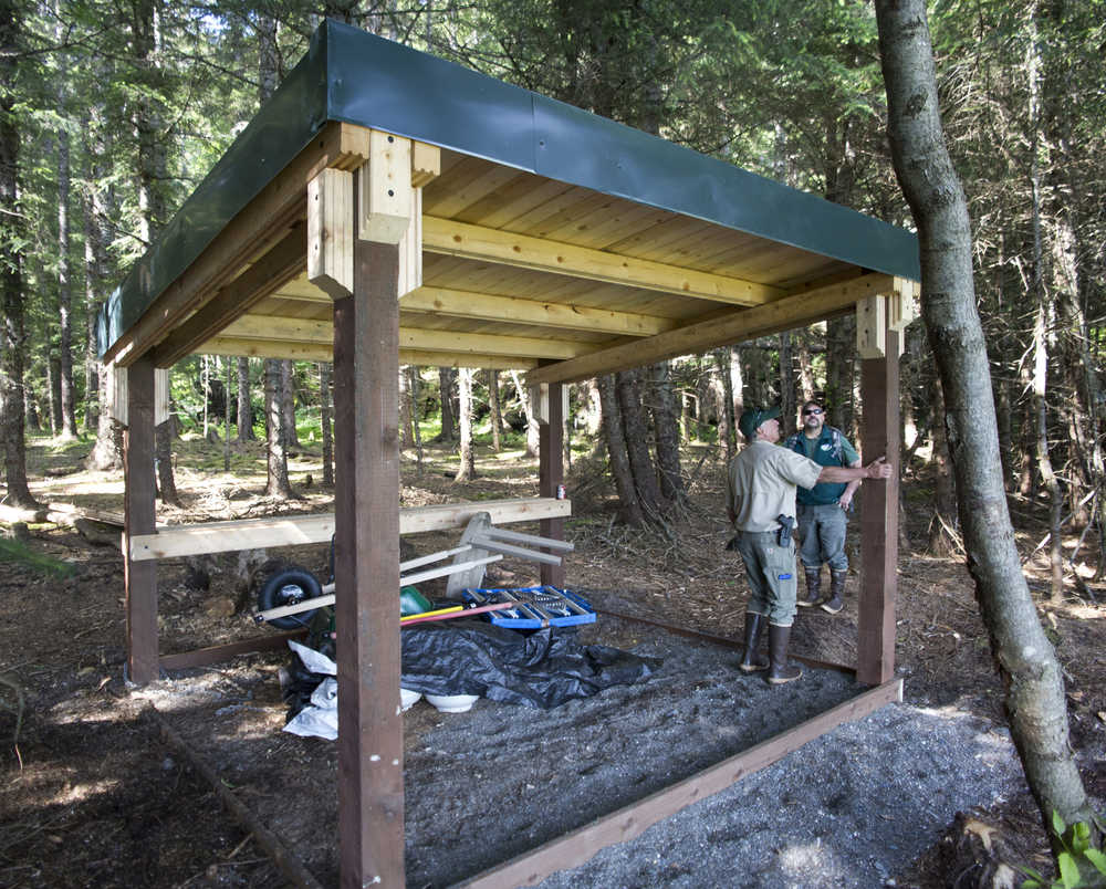 Kevin Murphy, right, chief ranger for the southeast area of Alaska State Parks, and Doug Drexel, southeast maintenance chief, view a shelter built down the beach from the new Salamander Cabin at Halibut Cove on Shelter Island on Thursday. The shelter is available without a reservation.