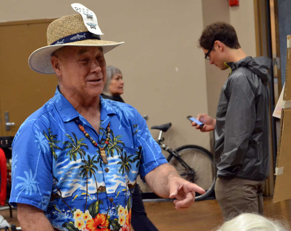Juneau Community Garage Sale organizer James Whycoff chats with another vendor during this year's sale, which took place Saturday morning at Centennial Hall.