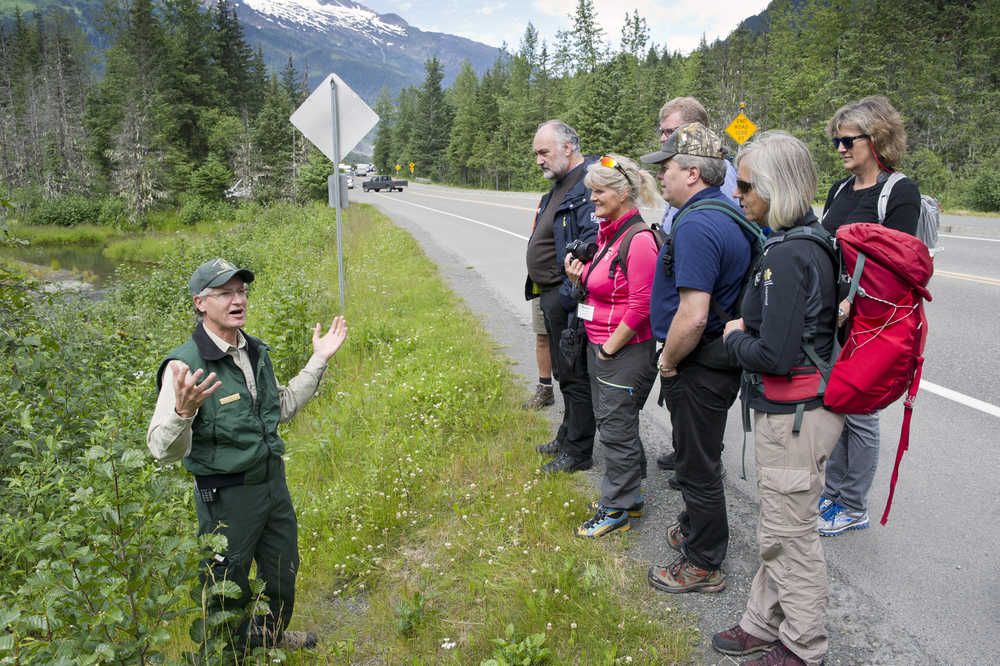 John Neary, director of the Mendenhall Glacier Visitor Center, gives a tour to a Norwegian tourism industry delegation on Monday. The group is the studying tourism in Southeast Alaska.