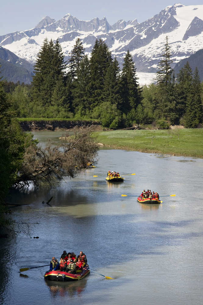 Tourists near the finish of their Mendenhall River rafting trip at the Brotherhood Bridge in June 2011.