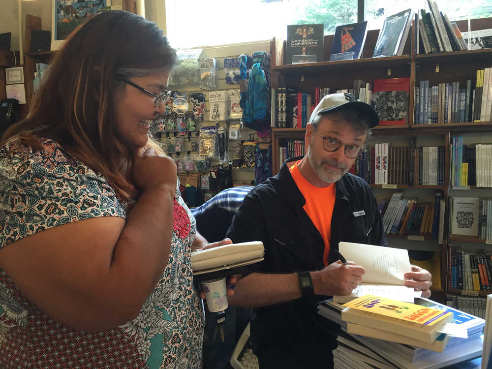 Pauline Williams gets a stack of books signed by internationally best-selling author Christopher Moore at Hearthside Books downtown on July 3.