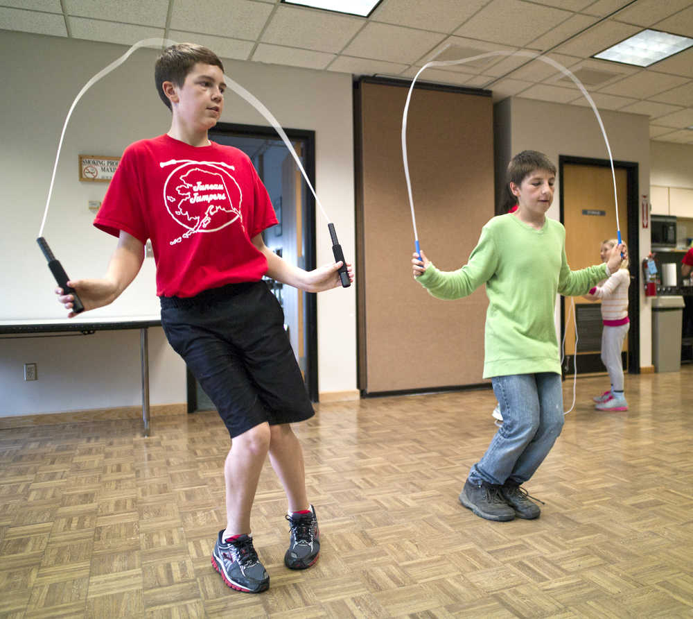 Juneau Jumper Garrett Klein, 12, left, shows Layne Cutnose, 12, some jumping pointers during a Wellness Wednesdays program at the Douglas Library on Wednesday.