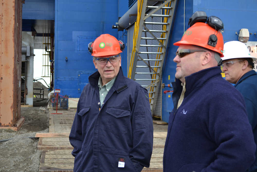 In this May 2015 photo, Gov. Bill Walker, left, is shown sporting a BP hardhat during a visit to Prudhoe Bay. In a July 6 interview, Walker said he expects a middle ground to be found between the state's demand for detailed gas marketing information from the North Slope producers and their refusal to provide it.