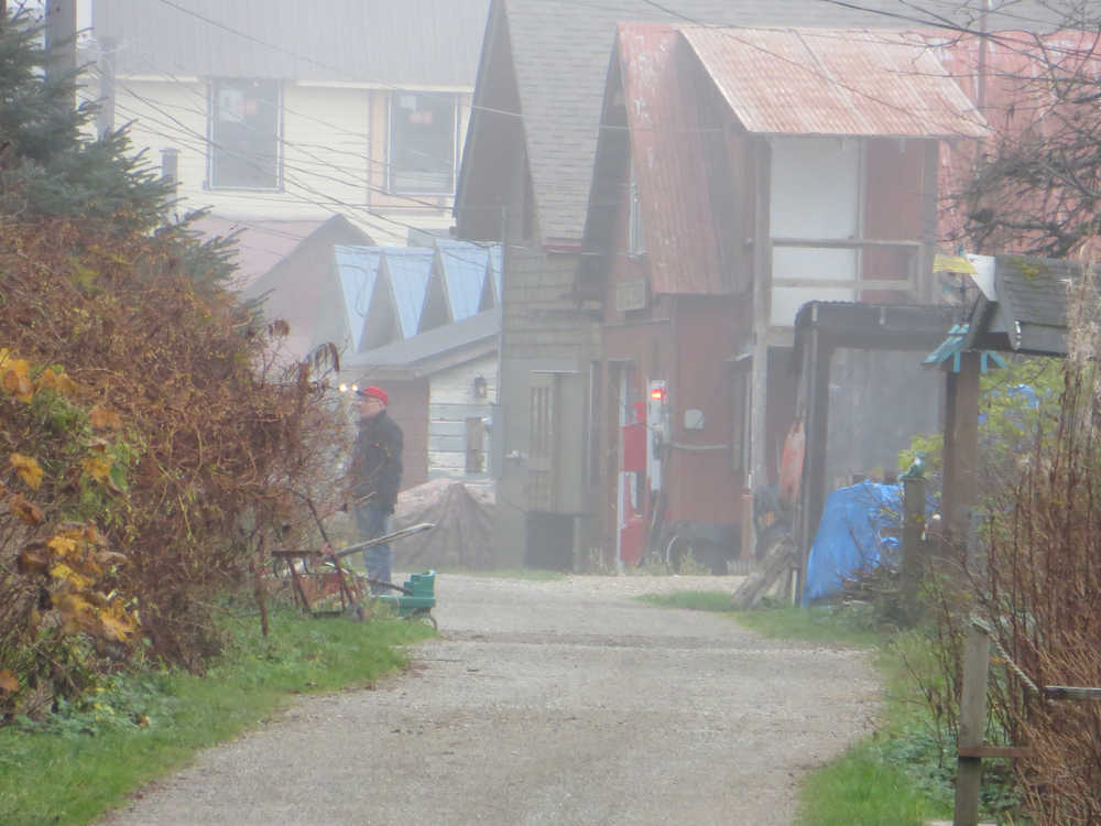 People chat in Tenakee Springs on a foggy fall day.