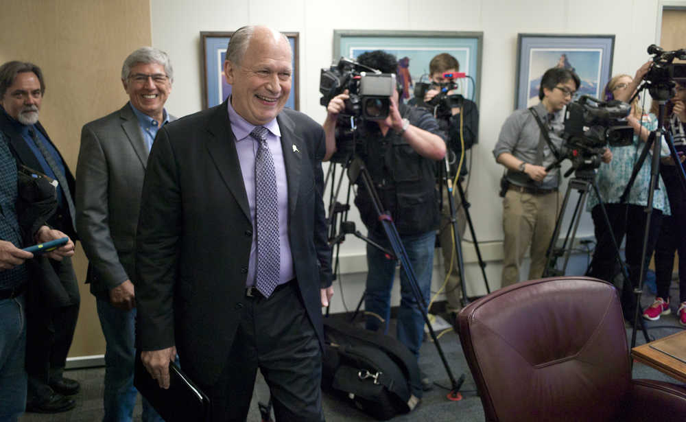 Gov. Bill Walker, center, walks into a Thursday press conference to show possible scenarios for Alaska economy if the Legislature fails to act during its special session. Following Walker are Lt. Gov. Byron Mallott and Revenue Department Commissioner Randy Hoffbeck.