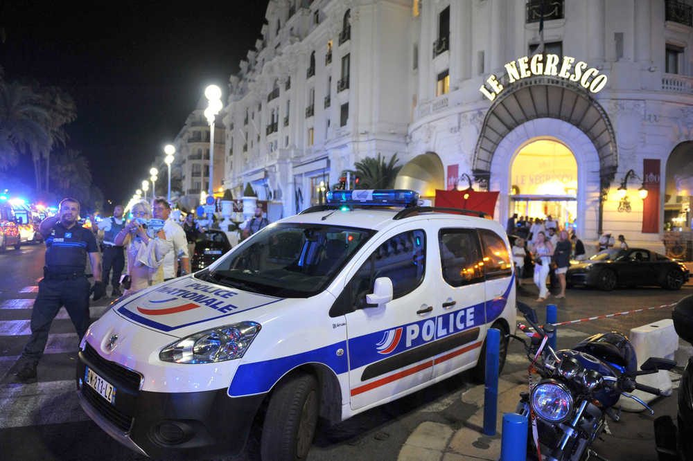 A Police car is parked near the scene of an attack after a truck drove on to the sidewalk and plowed through a crowd of revelers who'd gathered to watch the fireworks in the French resort city of Nice, southern France, Friday, July 15, 2016. A spokesman for France's Interior Ministry says there are likely to be "several dozen dead" after a truck drove into a crowd of revelers celebrating Bastille Day in the French city of Nice. (AP Photo/Christian Alminana)