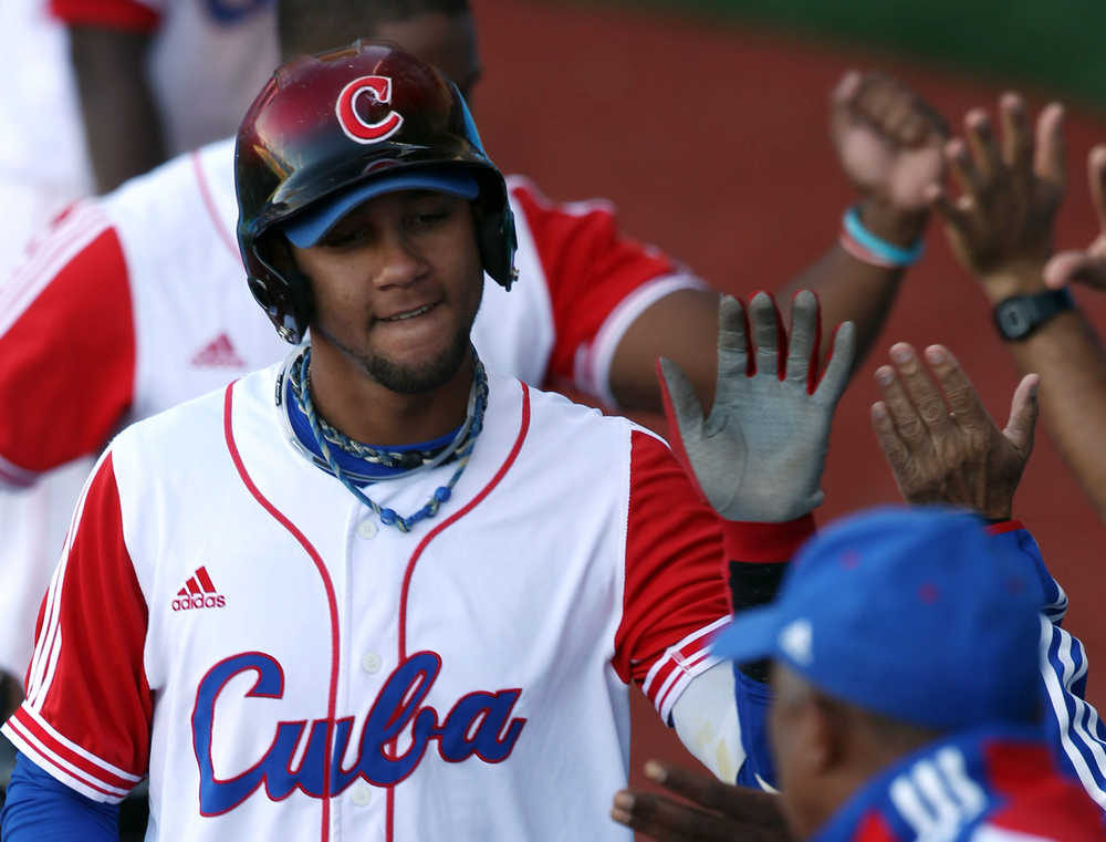 In this Oct. 25, 2011 photo, Cuba's Yulieski Gurriel is congratulated by teammates after hitting a two-run home run during  the bronze baseball match against Mexico at the Pan American Games in Lagos de Moreno, Mexico. The Houston Astros have signed Gurriel to a $47.5 million five-year contract, the team announced Saturday.