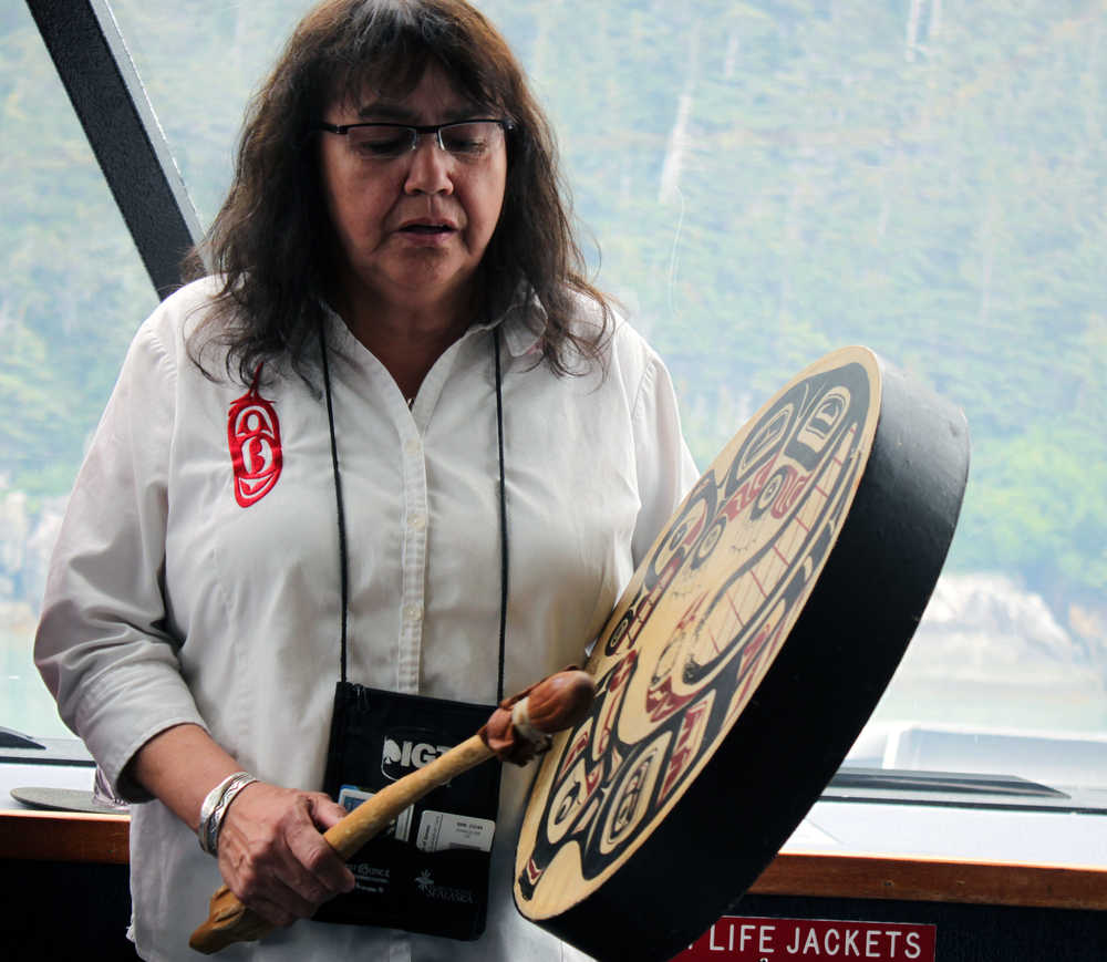 The Douglas Indian Association hosted an all-day boat trip to former Native village sites and the Taku Inlet on Friday. In this photo, Jeannie Lee sings and drums.