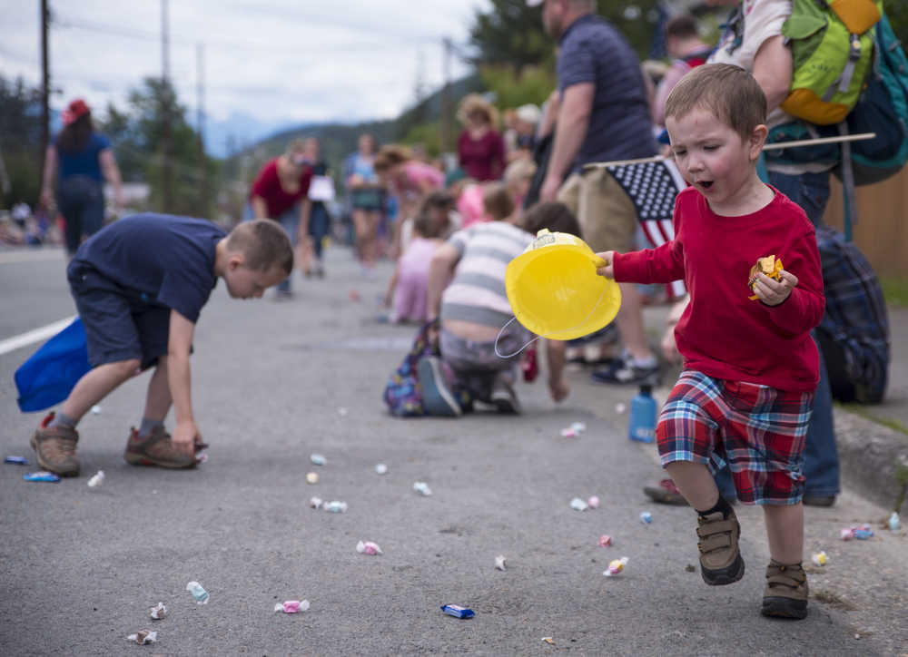 Children pick up candy scattered by parade participants on July 4, 2016 in Douglas. According to campaign finance reports, the biggest single expense incurred by Justin Parish in his House District 34 race against Cathy Munoz was more than $520 in candy and snacks for the parade. Among Munoz's contributors - two Juneau dentists and a statewide political action committee formed by dentists.
