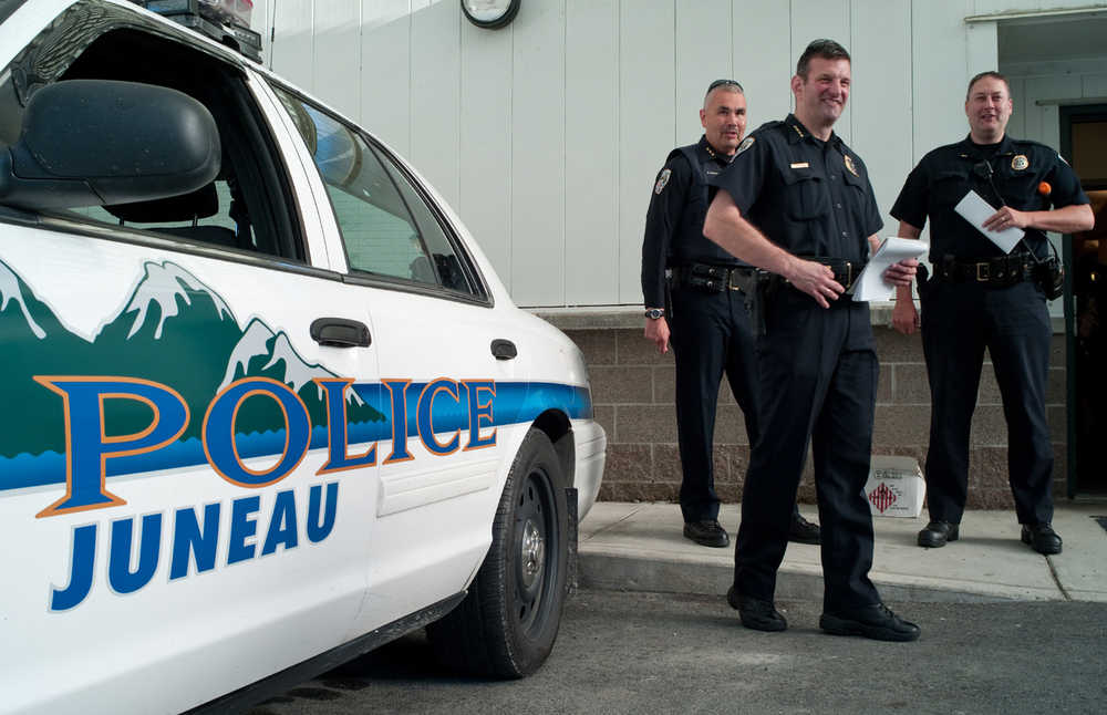 In this August 2013 file photo, Juneau Police Chief Bryce Johnson, center, gathers with officers at the Juneau Police Station during National Night Out. JPD is hosting a community event from 10:30 a.m. to 6 p.m. Wednesday at Marine Park to encourage a healthy dialogue about diversity and ending violence.
